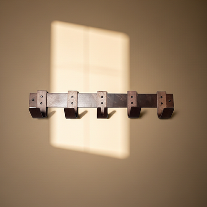 Wooden wall hook rack on a beige wall with soft shadow