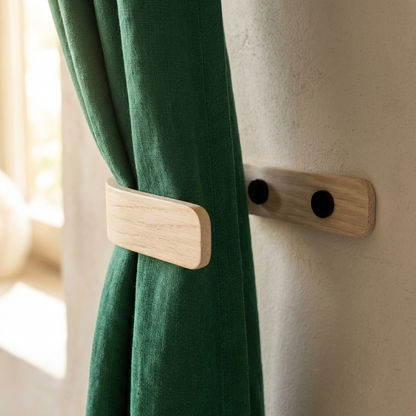 Green curtain with wooden tieback against a neutral wall
